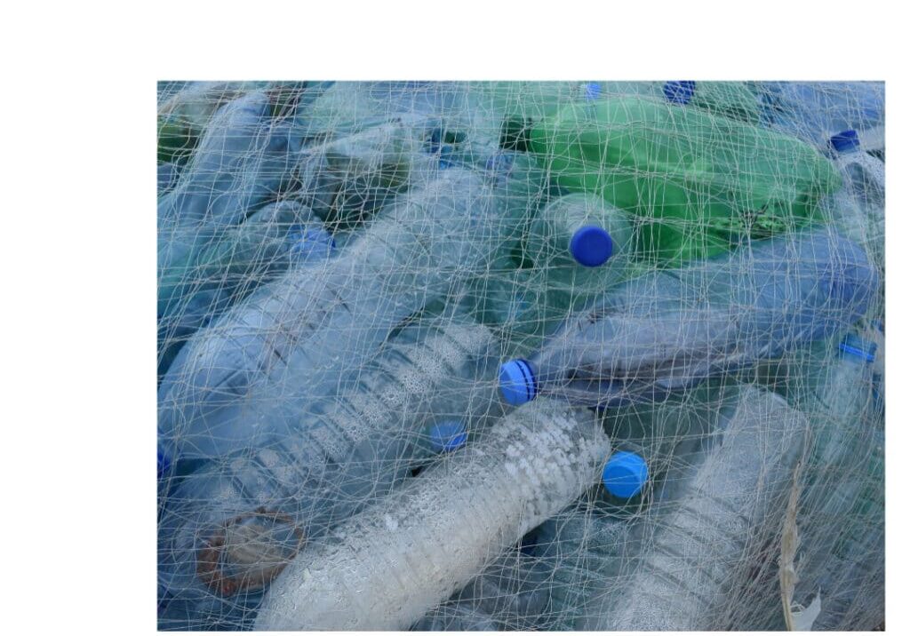 Discarded plastic water bottles in nylon netting