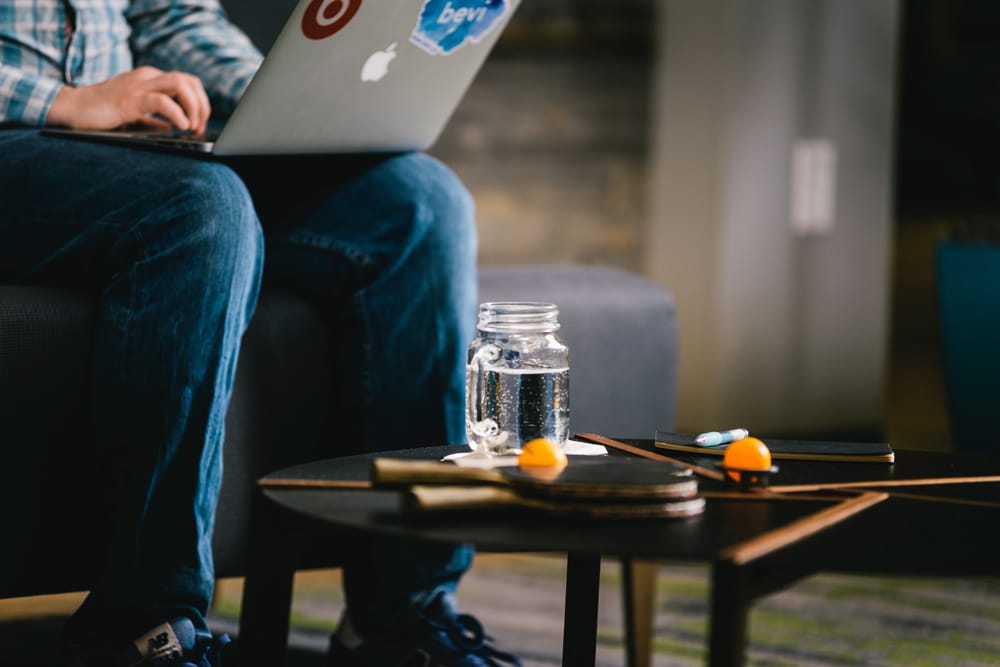 Gen Z Using Laptop Drinking Water Bevi