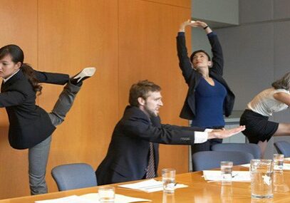 Workers in a conference room doing stretches