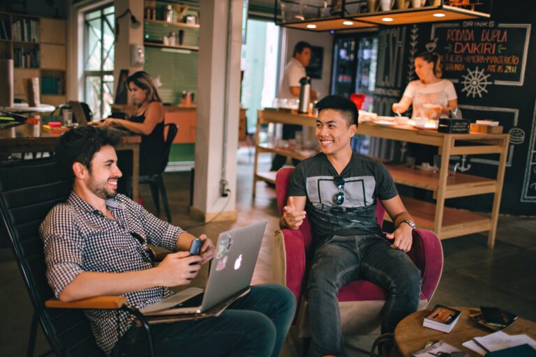 Two men smiling in an office