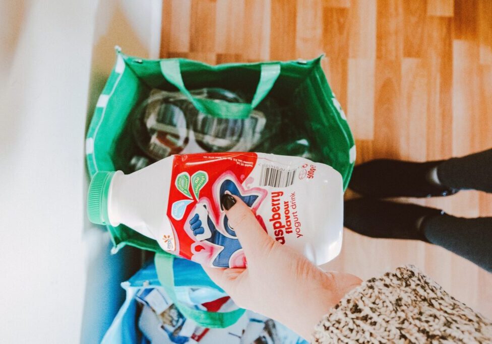 Hand holding a bottle to be recycled