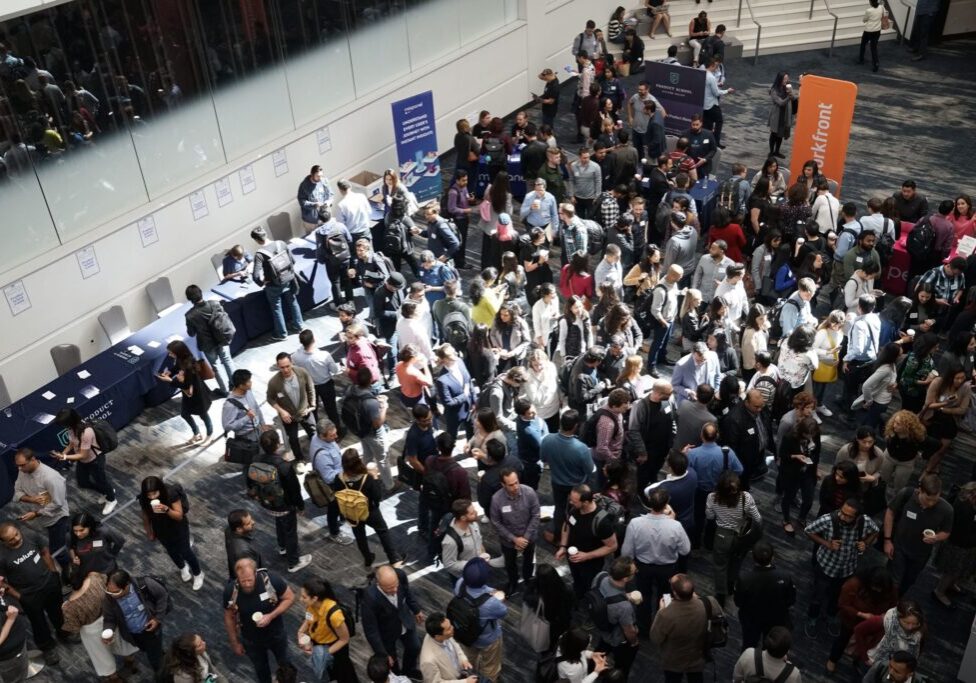 Trade show floor with people gathering and networking