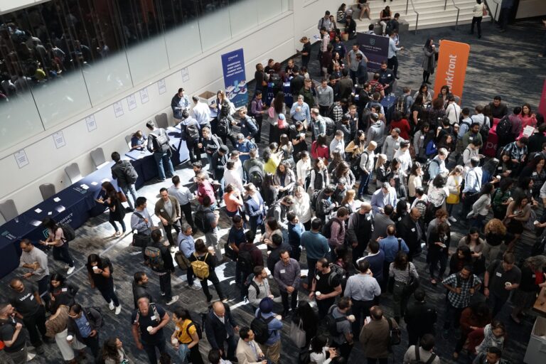 Trade show floor with people gathering and networking