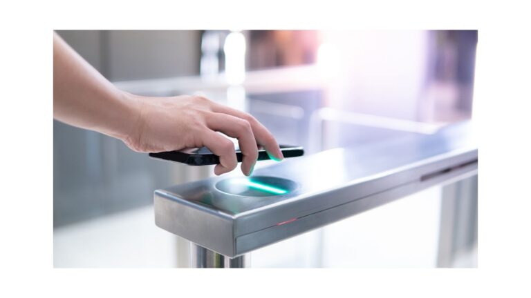 Hand holding mobile phone over an access control device